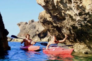 Kayaking meditation – paddling and swimming between rocks on the sea in the sparkling light of the morning sun.